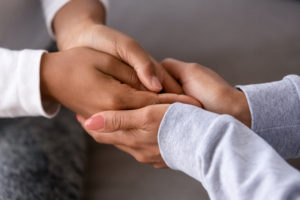 Parent holding hands with child.