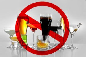 A collection of alcohol covered by a "no sign."