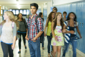 A highschool student standing in the hall. Long exposure with motion blur.