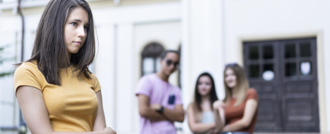 Classmates bullying a girl at schoolyard