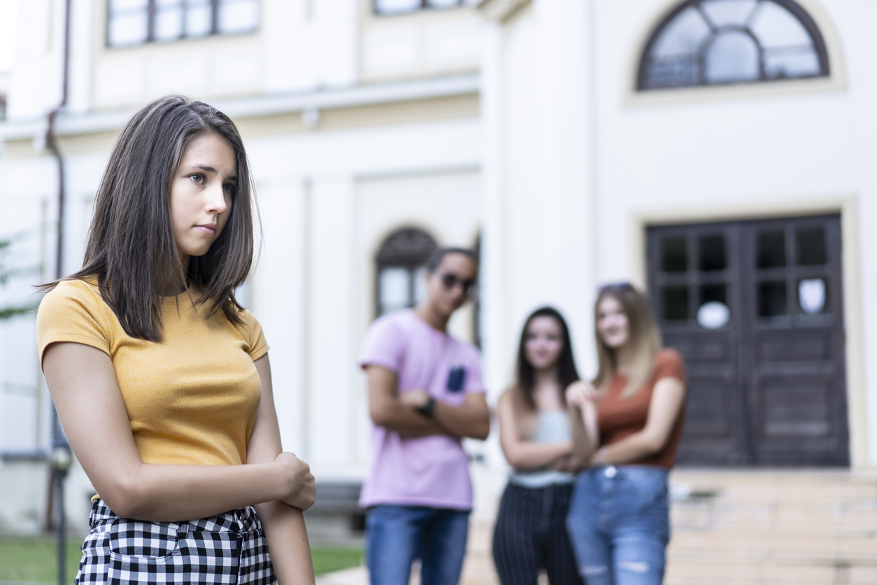 Classmates bullying a girl at schoolyard