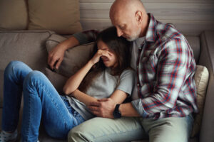 Loving father spending time with his depressed kid at home