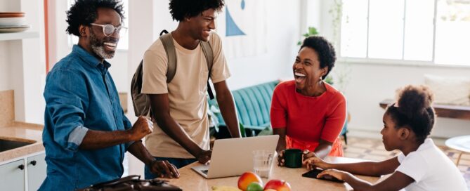 Family of four laughing and enjoying their morning routine at home