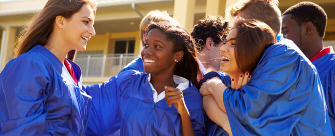 Teenagers smiling at each other on graduation day