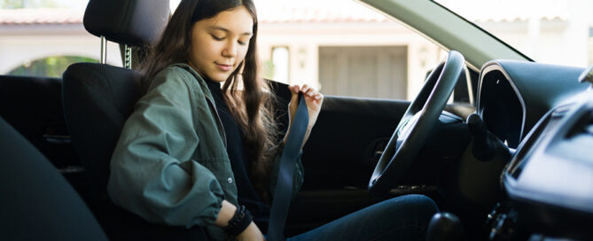 A teen girl driving a car