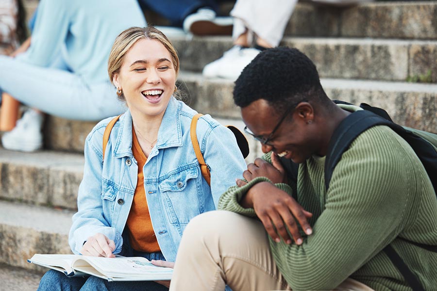 Two college students laughing with each other