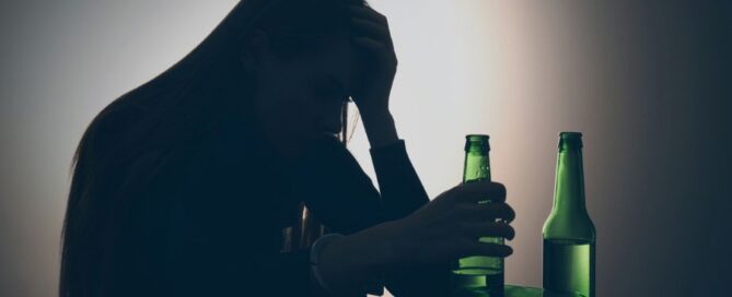 A woman holding a beer bottle