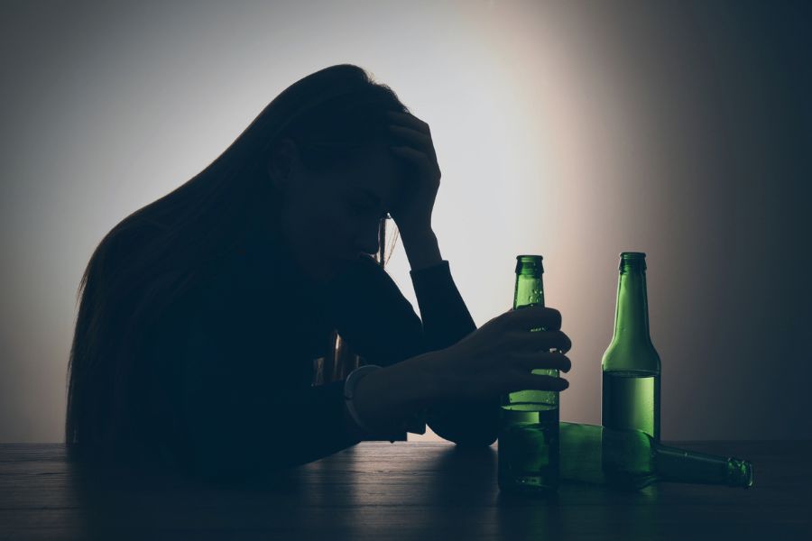 A woman holding a beer bottle